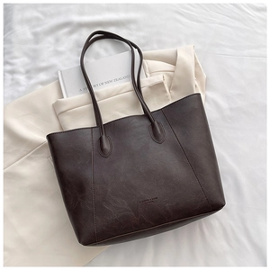 Detailed top view of large dark brown tote bag showing textured PU leather and straps