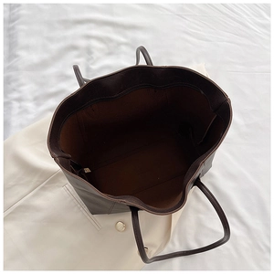 Interior view of deep brown tote bag showing large capacity and internal zipper pocket