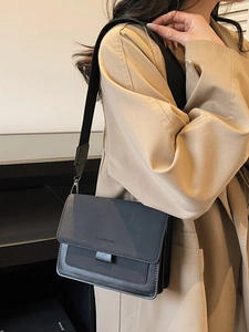 Minimalist black matte crossbody bag with wide shoulder strap and fashion lettering