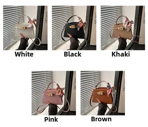 Detail view of crocodile pattern Kelly bags in five colors with silk scarf handles
