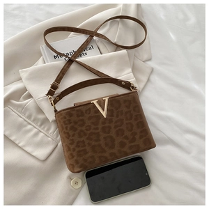Detail of leopard print handbag with gold V-logo and soft suede-like texture