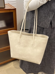 Minimalist cream white oversized tote bag in textured faux leather with shoulder straps