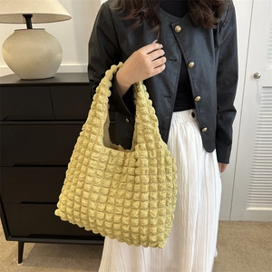 Minimalist yellow popcorn texture tote bag for women shown in a modern lifestyle setting
