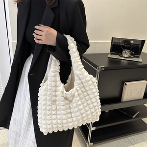 Minimalist white bubble texture shoulder bag for women in a modern office setting
