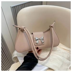 Close-up of pink baguette bag with silver bow buckle and twisted shoulder straps