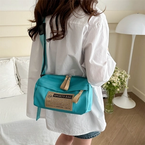 Stylish lake blue nylon crossbody sports bag with adjustable strap and casual design