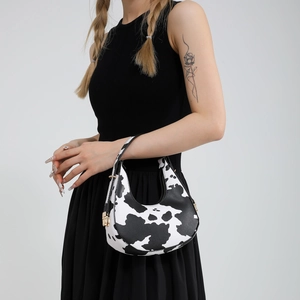 Trendy 2024 crescent underarm bag with cow print pattern and golden hardware details