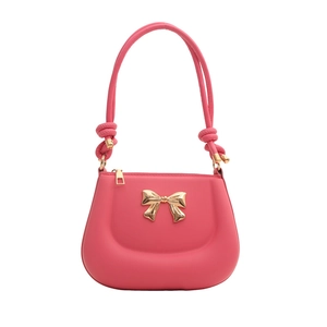 Pink lady-style crossbody bag with golden bow ornament and knotted handle detail