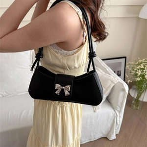 Retro black leather baguette bag with silver bow buckle and knotted shoulder strap