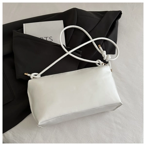 Detail of white minimalist faux leather tote bag with unique thin cord shoulder strap