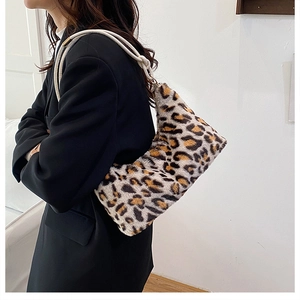 Detail of leopard print plush bag with thick white rope strap and metal hardware