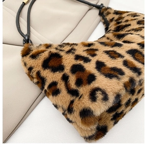 Close-up of leopard print plush shoulder bag with fluffy faux fur and black strap