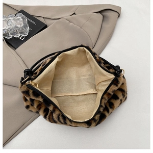 Detailed top view showing plush leopard faux fur texture, beige lining, and gold hardware