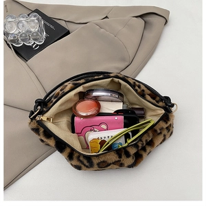 Top view of leopard print plush handbag interior showing large capacity for cosmetics