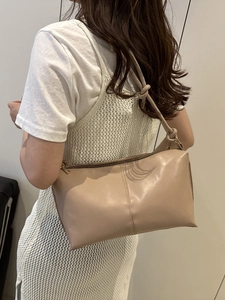 Chic beige faux leather shoulder bag with knotted strap and vertical decorative stitching
