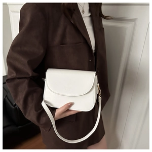 Detailed shot of pearl white leather crossbody bag with embossed Fashion Bags text