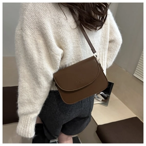 Detail showing the brown faux leather square cross-body bag with Fashion Bags engraving