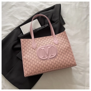 Close-up of pink Harajuku tote bag featuring embossed M logo and repeating pattern details