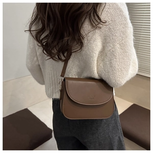 Detailed back view of a minimalist brown vintage crossbody bag with FASHION BAGS logo