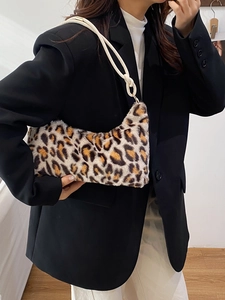 Chic leopard print faux fur underarm bag with white leather strap on a stylish model