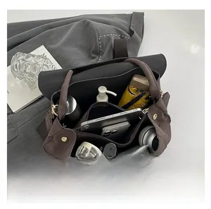 Detailed view of the large tote bag showing interior storage for tablets and gadgets