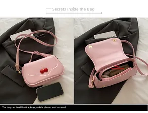 Macro detail of pink cherry crossbody bag showing internal capacity and wave flap