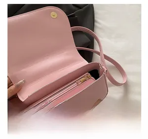 Detail of pink PU leather crossbody bag showing inner golden zipper and magnetic closure