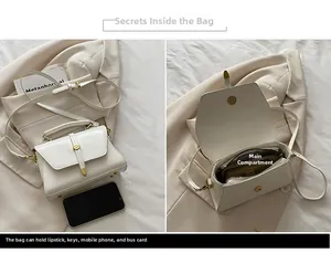 Detail view of white trapezoid crossbody bag showing interior capacity and golden magnetic clasp