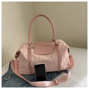 Pink large travel tote with wrinkled texture fabric, long shoulder strap and top handles