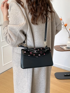 Black glossy leather shoulder bag with pink cherry blossom embroidery and heart patterns