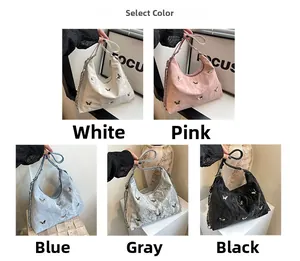 Detail view of large tote hobo bag in five colors with metallic butterfly and chain strap