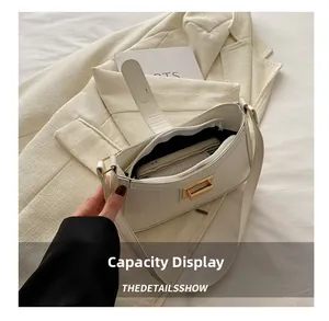 Interior view of cream-colored small square bag showing large storage capacity