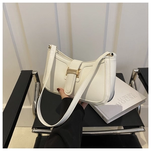 Detail of white leather shoulder bag with sleek gold metal buckle and urban minimalist design