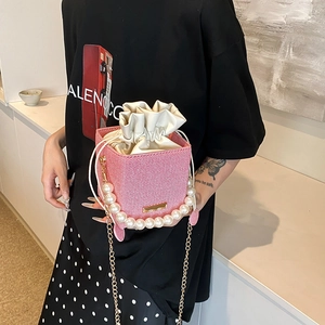 Pink and white striped mini bucket bag with pearl handle and golden chain strap