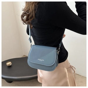 Detail view of Morandi blue crossbody bag featuring matte leather and letter print