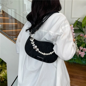 Black crescent shoulder bag with heart charms, pearl chain, and FASHION & BAGS logo