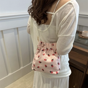 Pink corduroy bucket bag with strawberry embroidery and decorative pearl strap