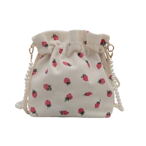 White corduroy strawberry print bucket bag with elegant pearl beaded strap and gold buckle