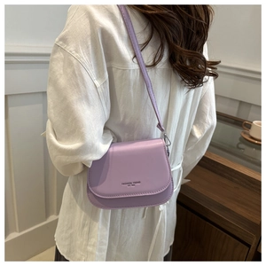 Close-up of a light purple saddle bag featuring Fashion Trend print and crossbody strap