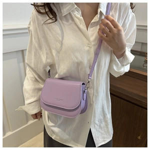 Detail of lavender leather crossbody bag featuring Fashion Trend embossed logo and stitching