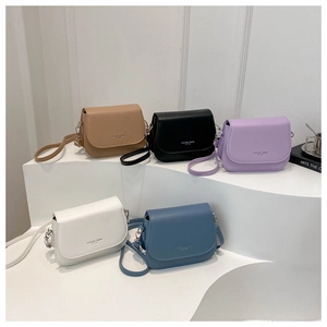 Minimalist rectangular saddle bags in five colors on a clean display stand