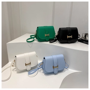 Detailed view of four colorful mini square crossbody bags with gold T-bar metal clasps