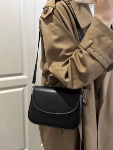 Minimalist black leather crossbody bag with flap and FASHION BAGS embossing detail