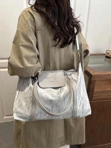 Elegant large silver tote bag with pleated texture and adjustable strap for women