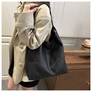 Detailed close-up of black woven texture on a large capacity shoulder tote hobo bag