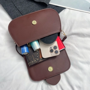 Interior view of brown leather handbag showing large capacity for phone and wallet