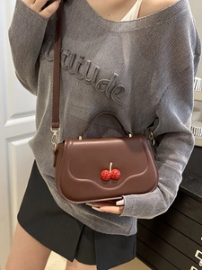 Brown leather crossbody bag with cherry diamond accent and golden chain strap for women