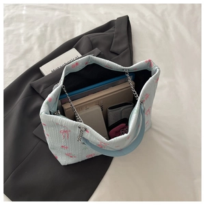 Detail of blue floral tote interior showing large capacity for books and tablet