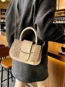 Elegant beige woven texture handbag with gold buckle and adjustable crossbody strap