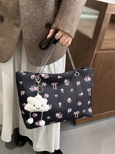 Black floral tote bag with pink rose patterns, chain strap, and cute cloud charm pendant